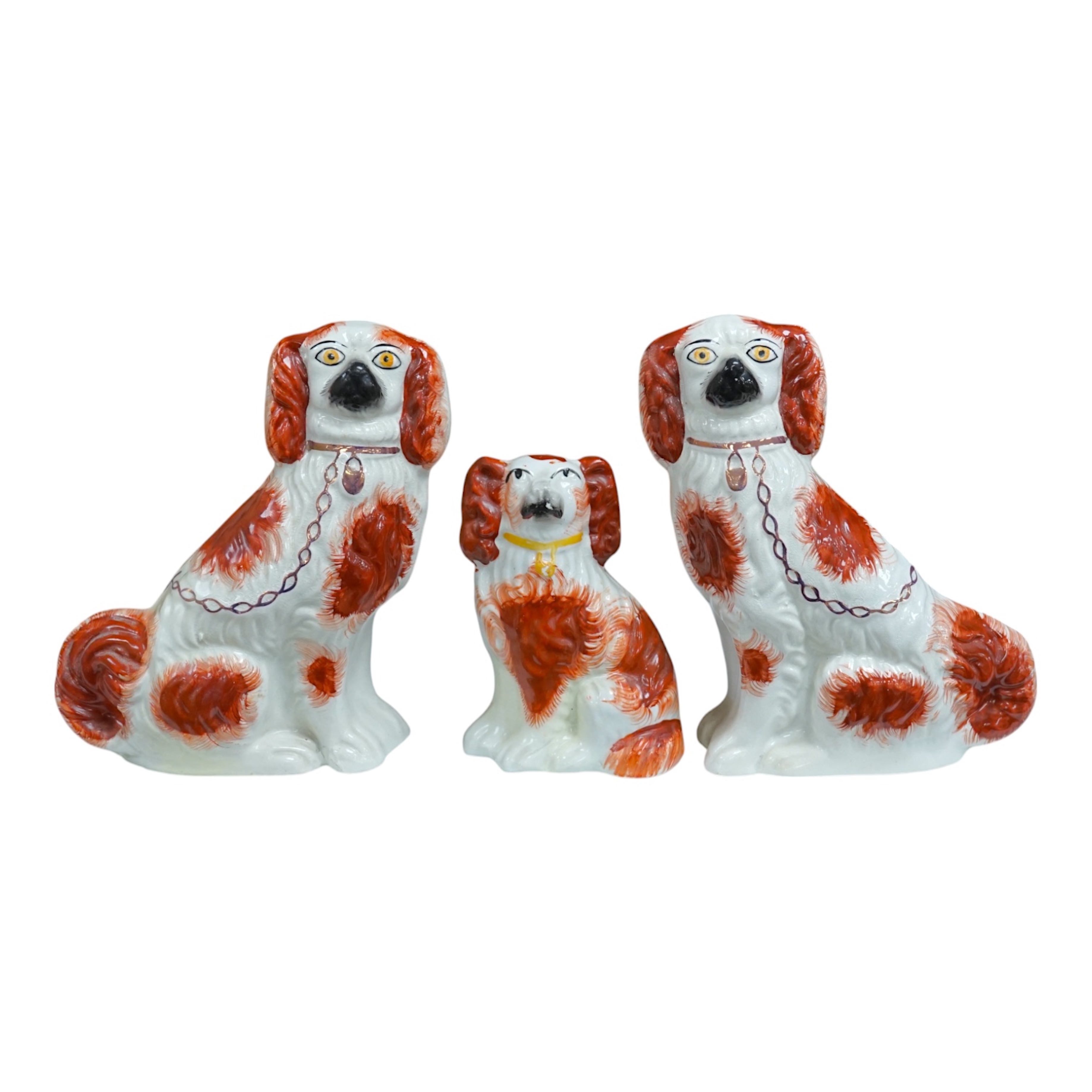 A pair of Staffordshire potter spaniels, and a similar smaller example, taller 18cm. Condition - smaller and one larger heavily restored